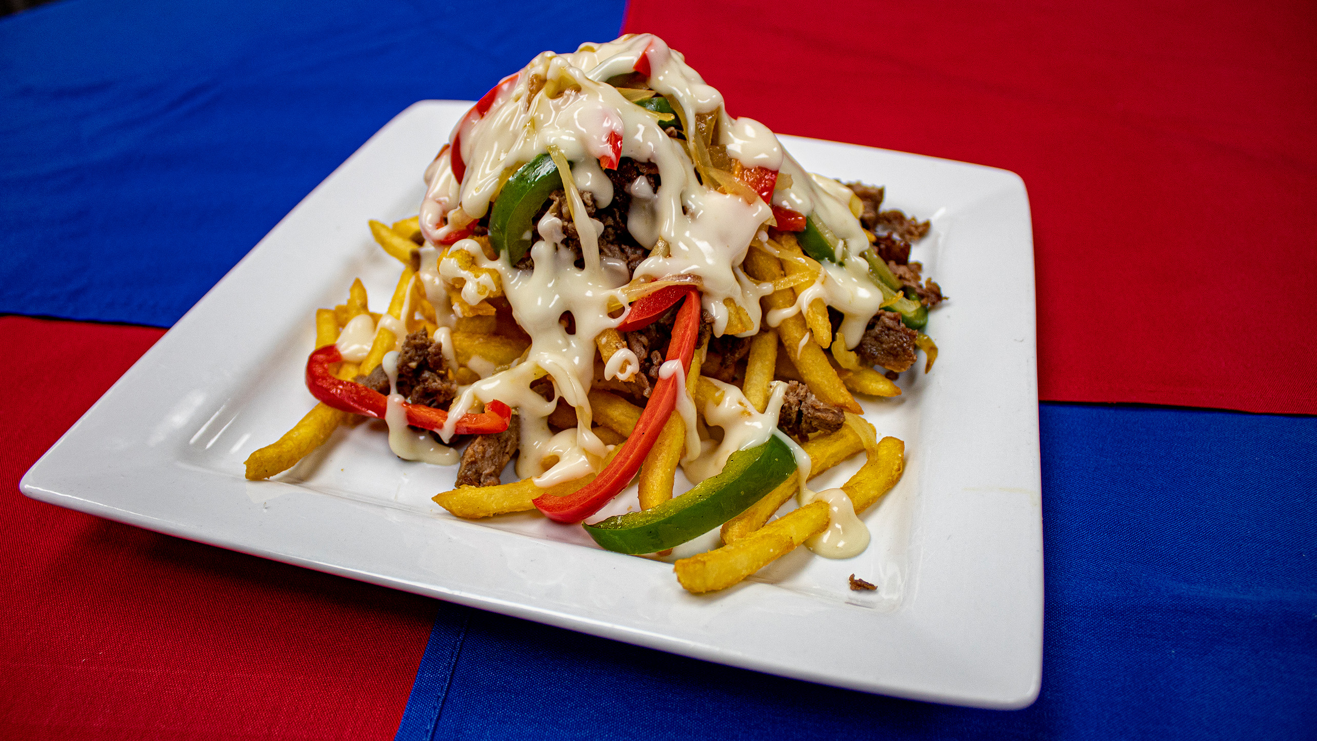 <strong>Philly Fries</strong> – Crispy golden French fries topped with shaved sirloin, sautéed peppers and onions and drizzled with white queso. <em>Submitted by Terry Szczechowski</em>