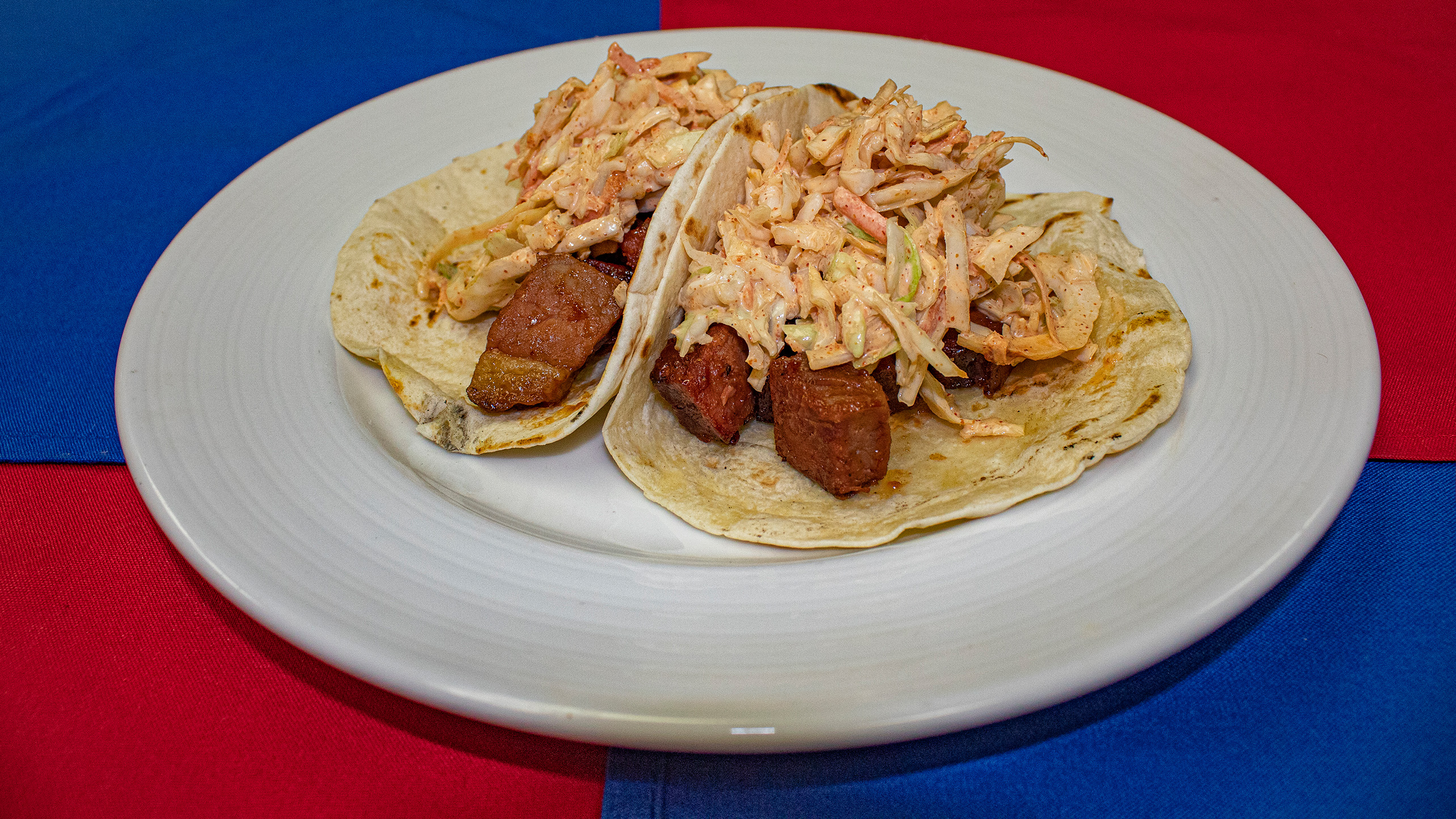 <strong>Burnt End Tacos</strong> – Twice cooked brisket cap tossed with sauce and topped with chipotle slaw on two flour tortillas. <em>Submitted by Garrett Hibiske</em>