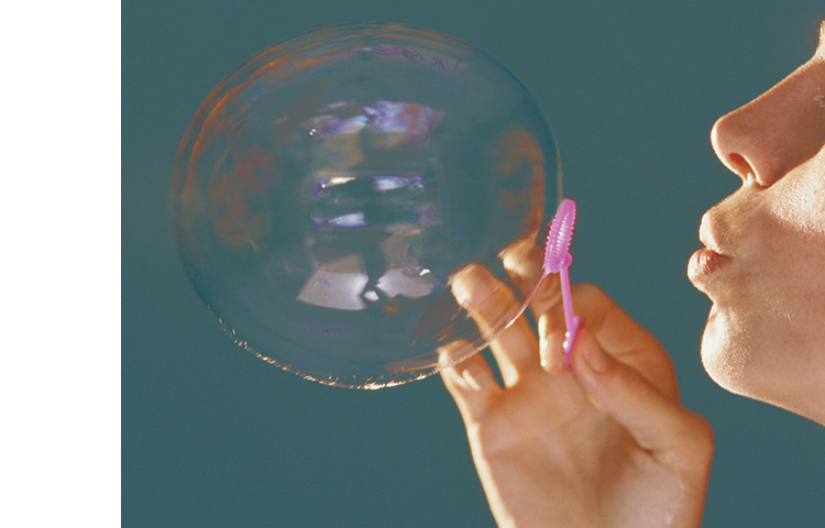 Person blowing a bubble to help learn the pursed-lip breathing technique.
