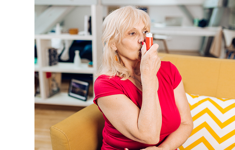 Person using an inhaler as prescribed to relieve chronic lung disease symptoms.