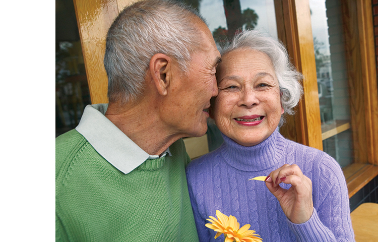 Two people smiling and being affectionate.