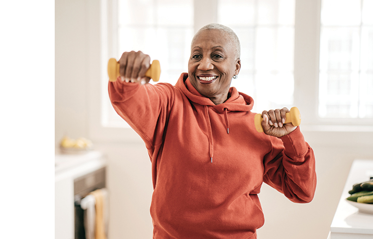 Person using hand weights and smiling.