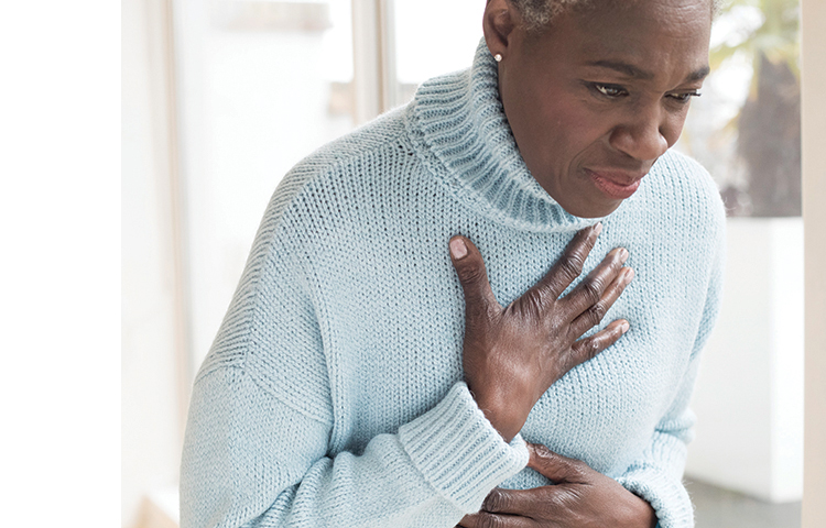 Person holding hand to chest and looking upset.