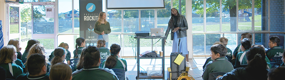 Two PROJECT ROCKIT Presenters amid a workshop with Primary School students
