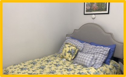  Sensor on wall near bed.  Cords are mounted on surface of wall and secured by clips or channel cover. 