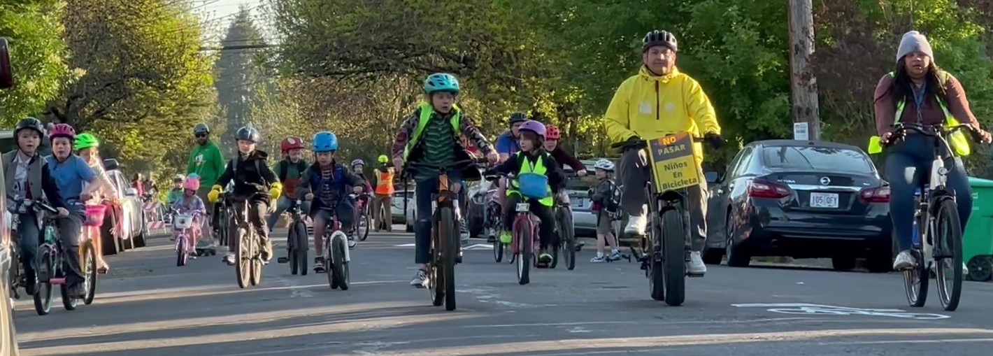 the James John bike bus on the way to school, with ride leaders at the front followed by students.