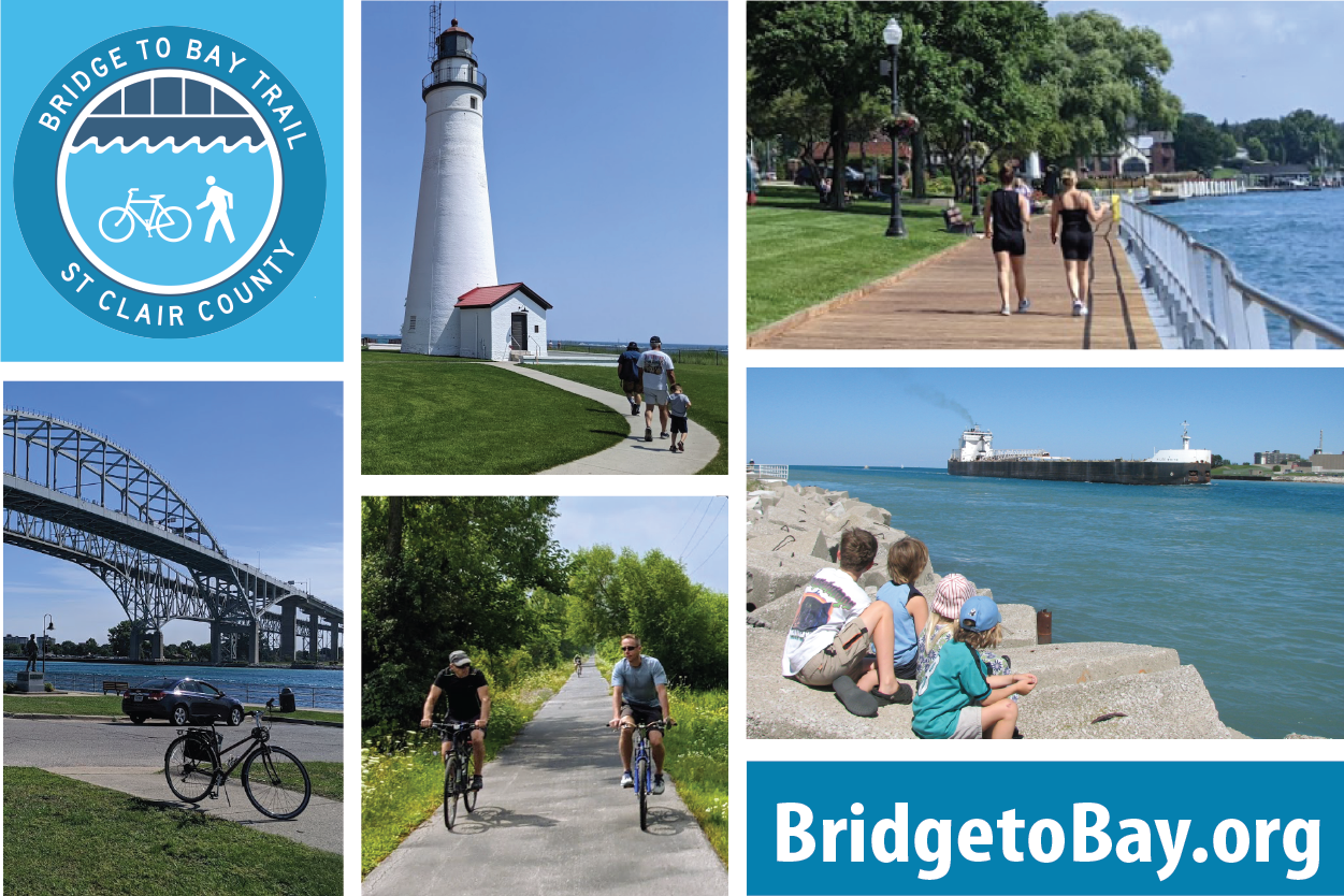Collage of photographs promoting Bridge to Bay Trail in St. Clair County, featuring a lighthouse, people walking on a waterfront boardwalk, cyclists on a trail, a bridge over water, and children sitting by a harbor with a ship. Includes the Bridge to Bay logo website URL "BridgetoBay.org".