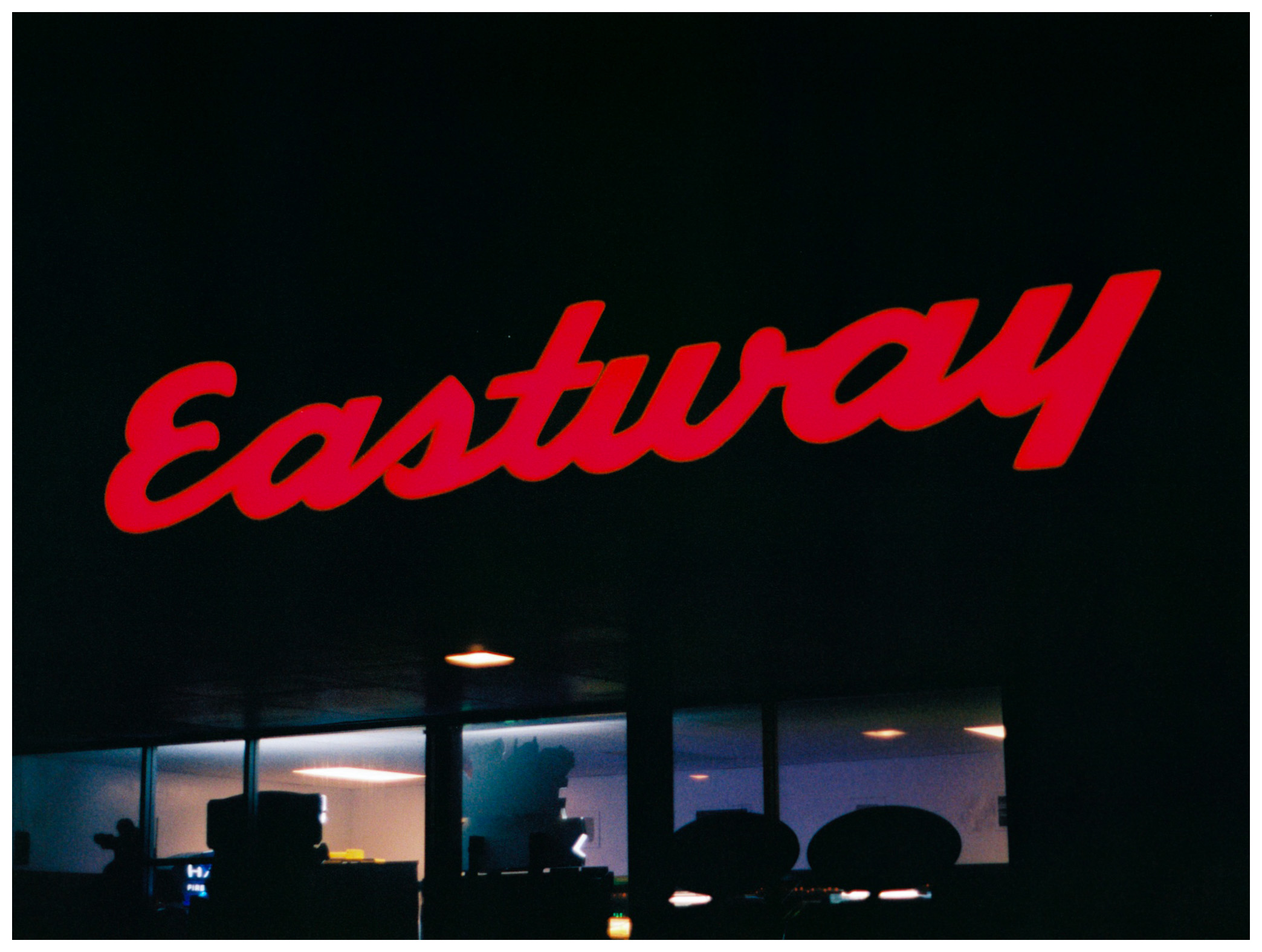a photo showing the Eastway sign lit up at night - "Eastway" by Cole Casper