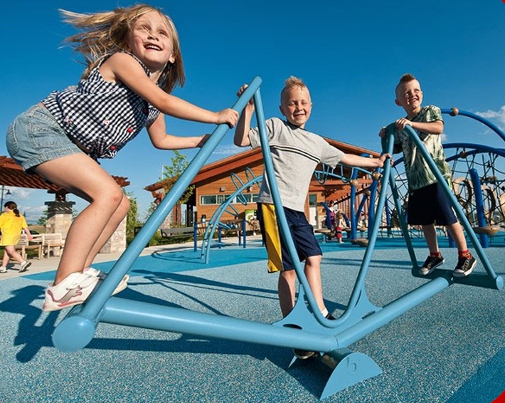 kids playing on a  stand up seesaw