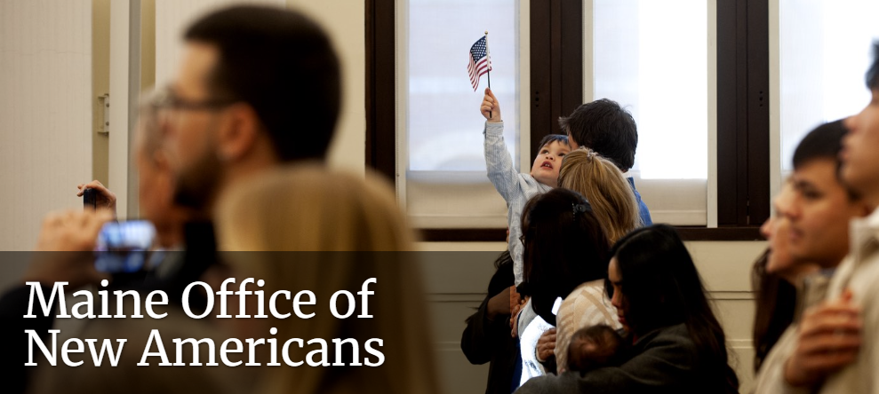 small child holding up American flag in a crowd