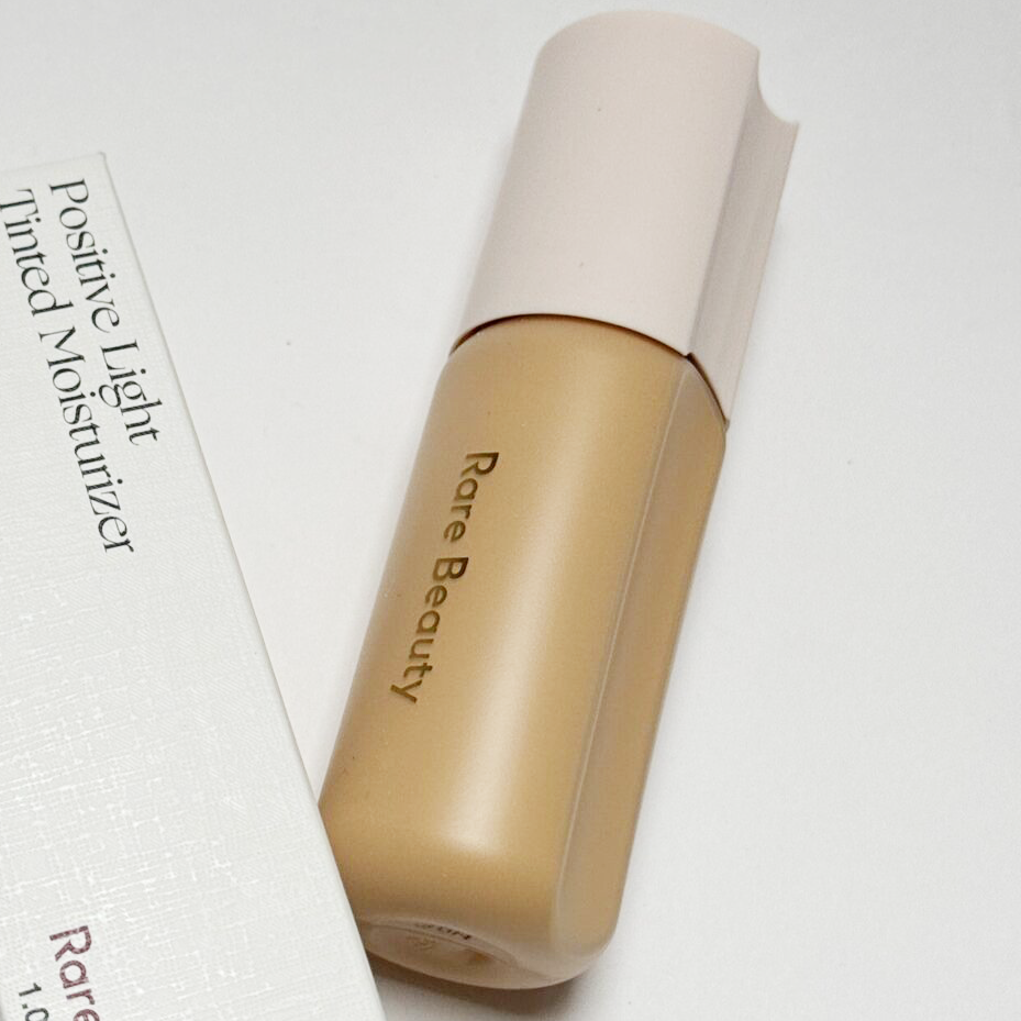 Rare Beauty Tinted Moisturiser - a cylindrical bottle with a bite out of it like a cookie