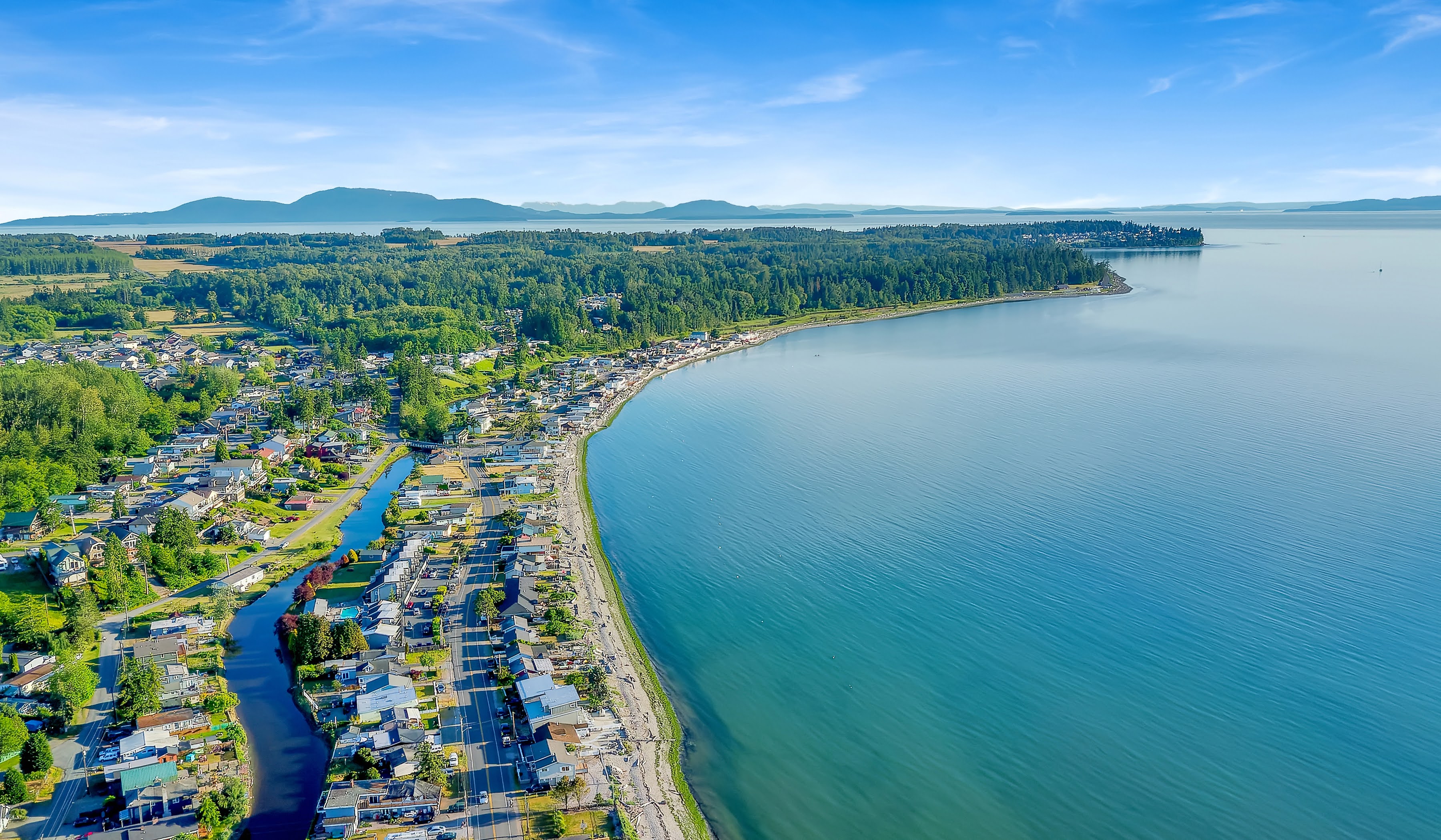 An aerial view of Birch Bay with mountains in the background. 