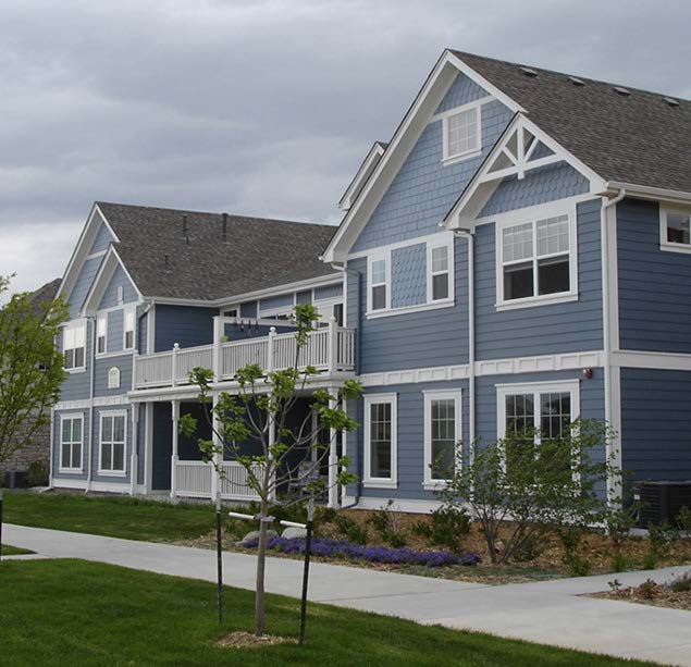 A large blue building made of connected pitch-roof structures.