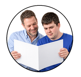 A man reading a document to a younger man